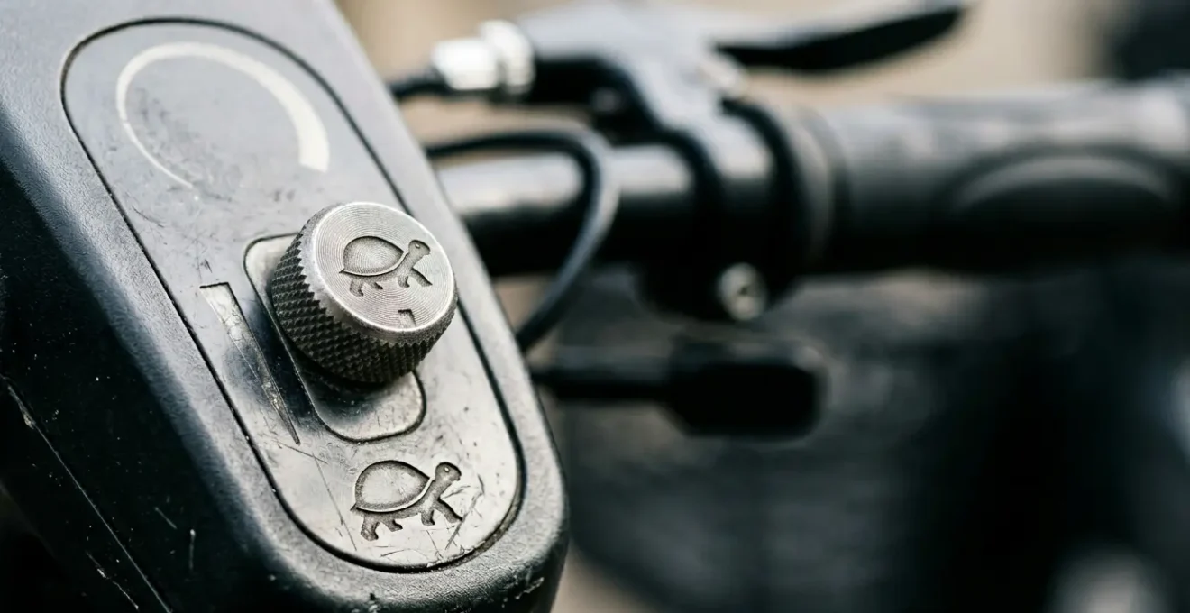 Close-up view of a Class 3 mobility scooter control panel showing the speed restriction toggle switch in pavement mode