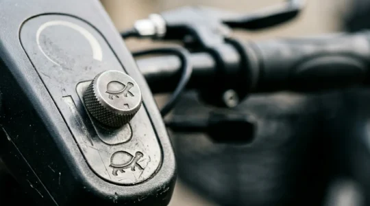 Close-up view of a Class 3 mobility scooter control panel showing the speed restriction toggle switch in pavement mode