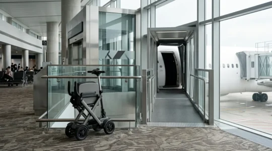 Modern folding mobility scooter near airport gate boarding area ready for travel