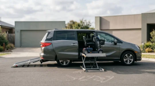 Side-by-side comparison of under-floor platform lift and fold-out ramp systems on modern accessible van exterior