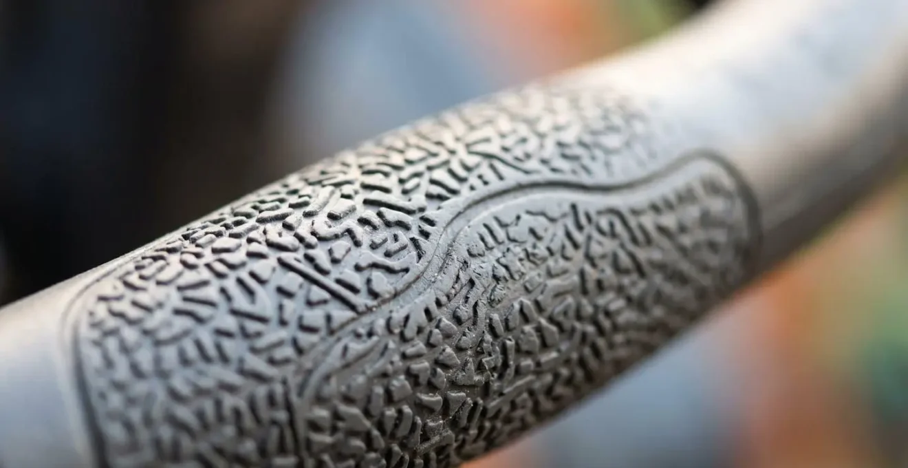 Extreme close-up macro photograph of ergonomic delta tiller control surface showing textured grip designed for arthritic hands