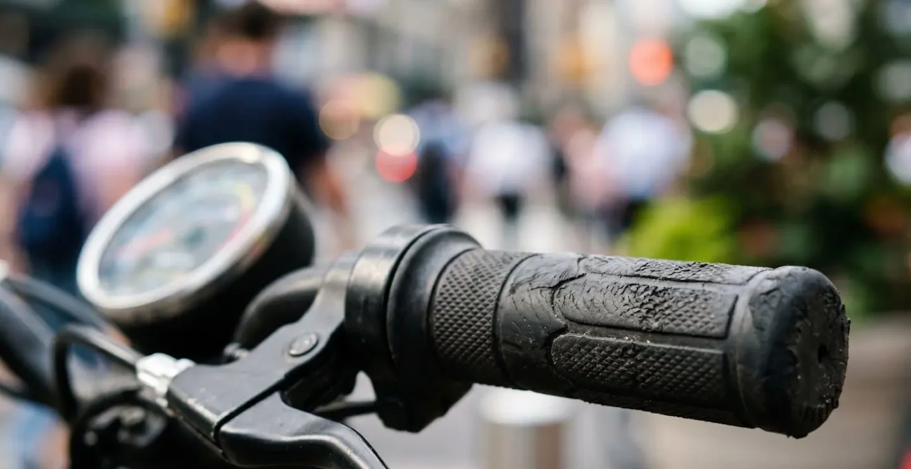 Close-up view of electric scooter battery indicator showing power drain during an uphill ride