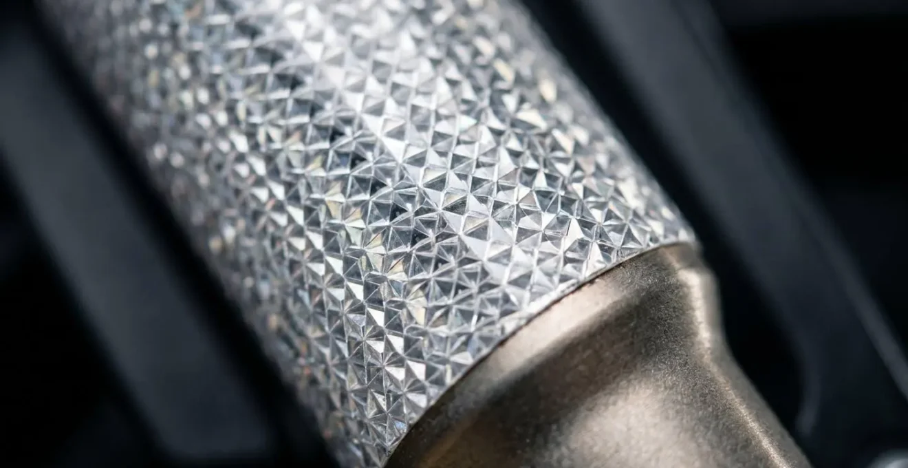 Close-up macro detail of prismatic reflective tape on motorcycle fork showing micro-prism structure