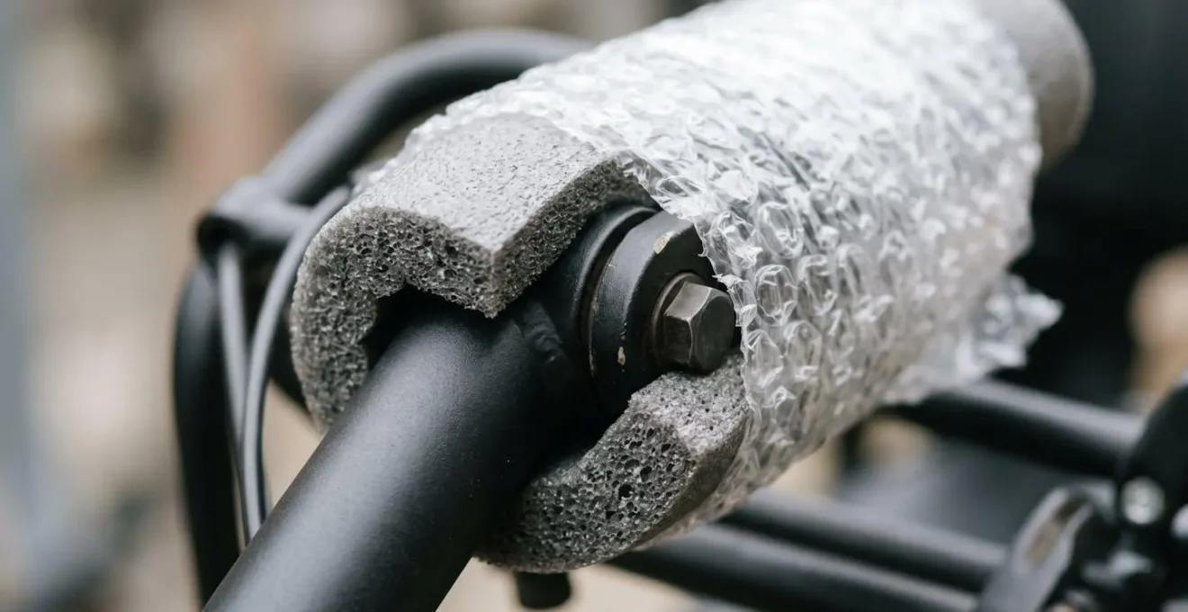 Close-up detail of protective foam padding applied to mobility scooter tiller joint and control mechanism