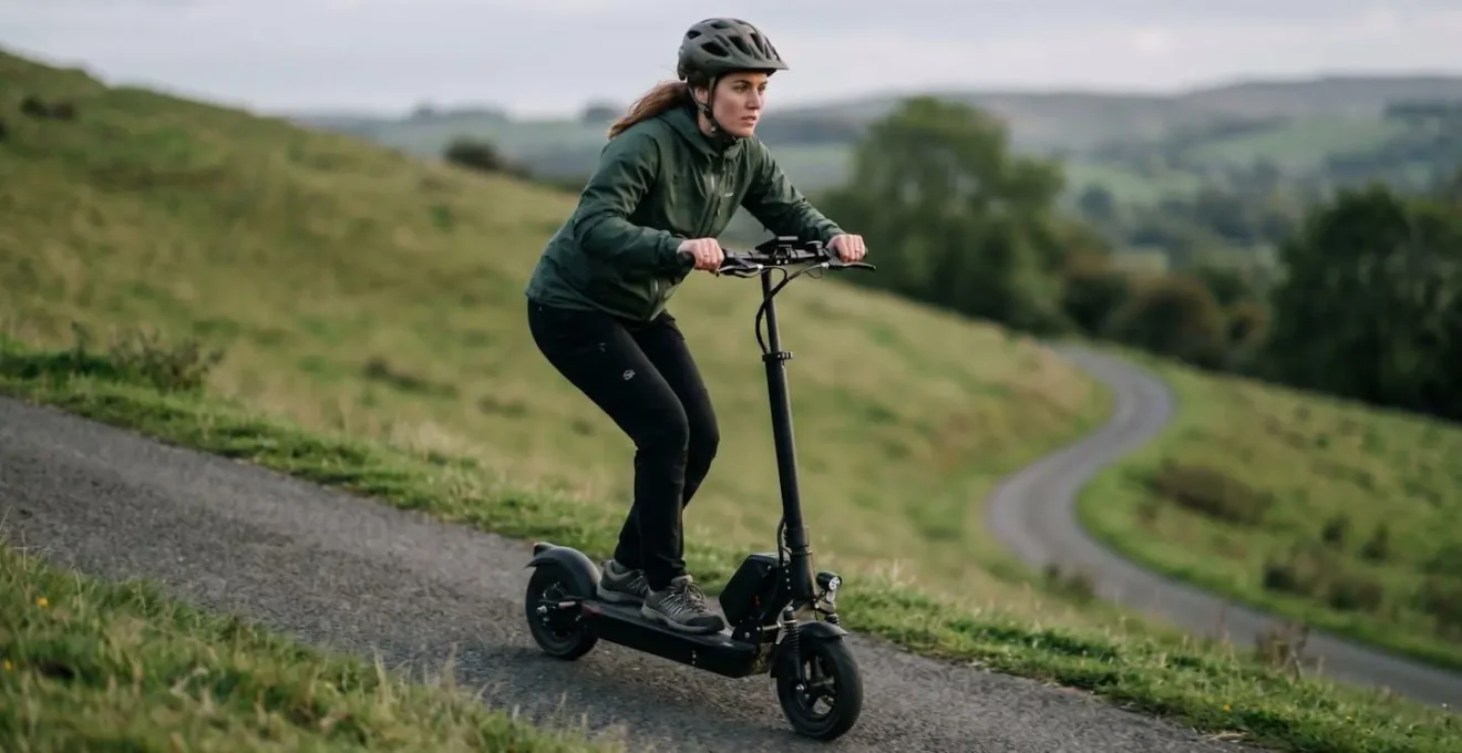 Rider demonstrating proper body position with weight shifted forward while navigating steep incline on electric scooter